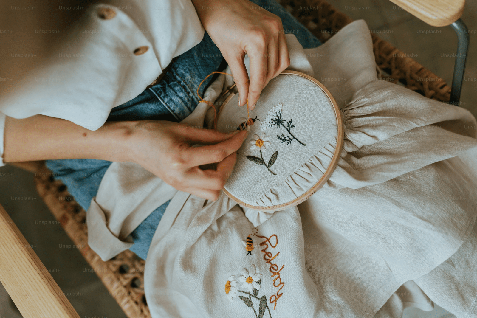 a girl is doing embroidery